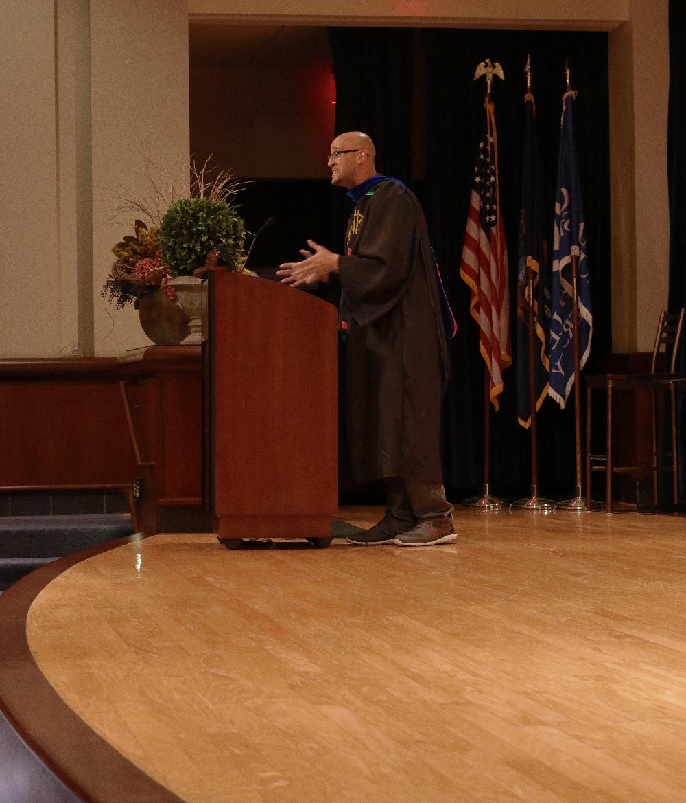 Professor Louis Moore at podium